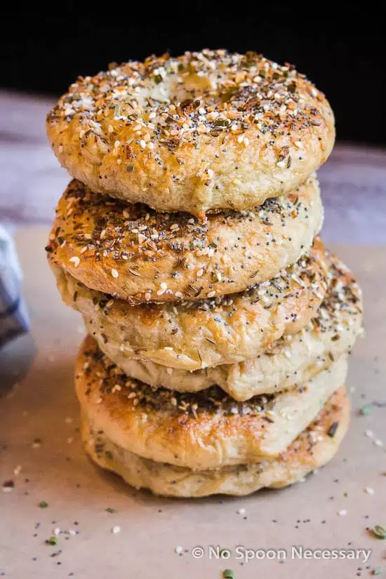 Straight on photo of a stack of six freshly baked everything bagels.