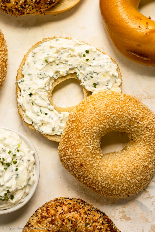 Overhead photo of half a bagel topped with cream cheese spread.