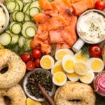Overhead photo of bagel and lox breakfast sandwich platter with salmon, veggies, cream cheese and bagels.