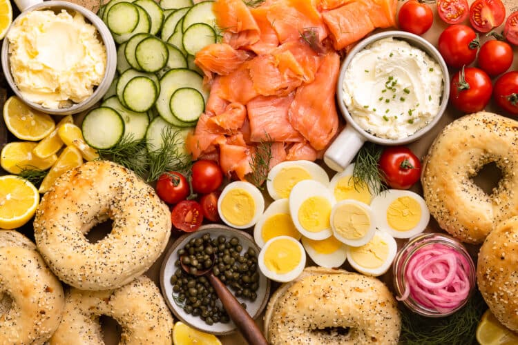 Overhead photo of bagel and lox breakfast sandwich platter with salmon, veggies, cream cheese and bagels.