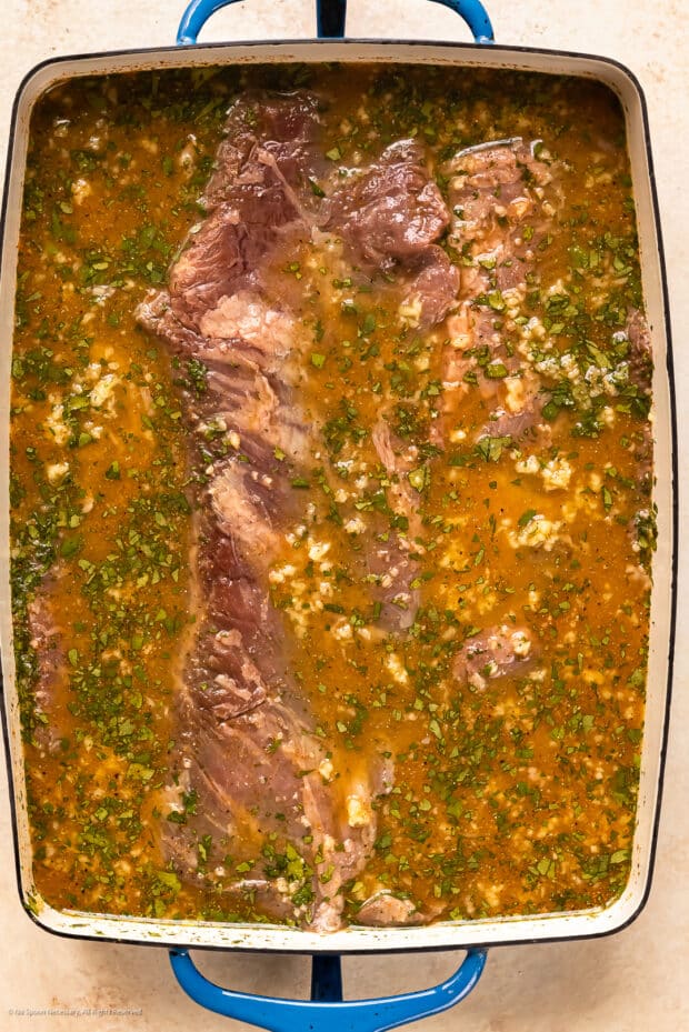 Photo of raw skirt steak in a fajita marinade.
