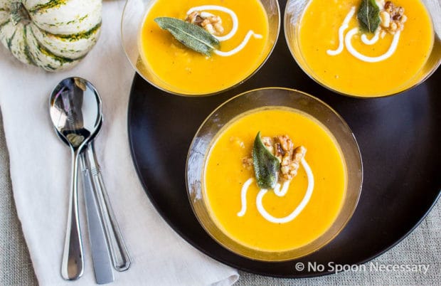 a tray of winter squash soup in clear bowls