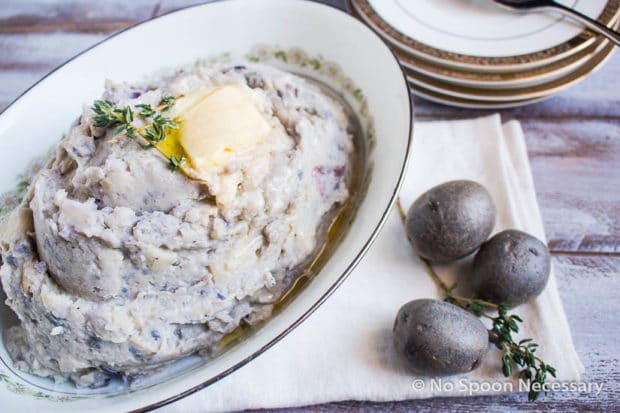 Purple potato mash in a serving dish.