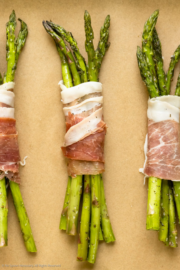 Overhead photo of asparagus spears wrapped in parma ham.