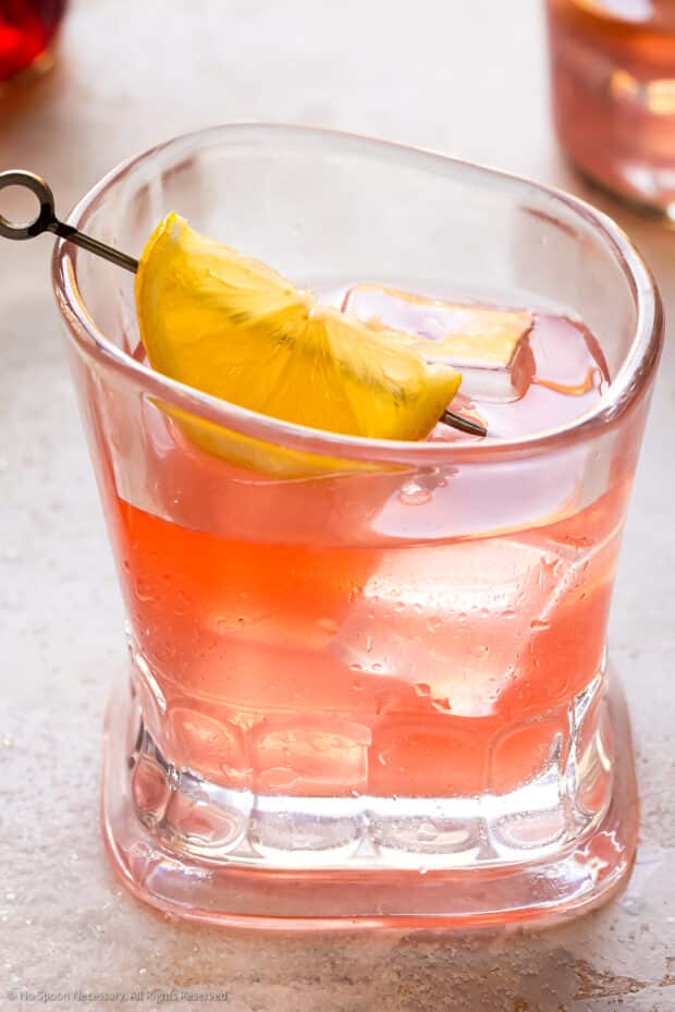 Close up photo of a pink lemonade with vodka in a short cocktail glass.