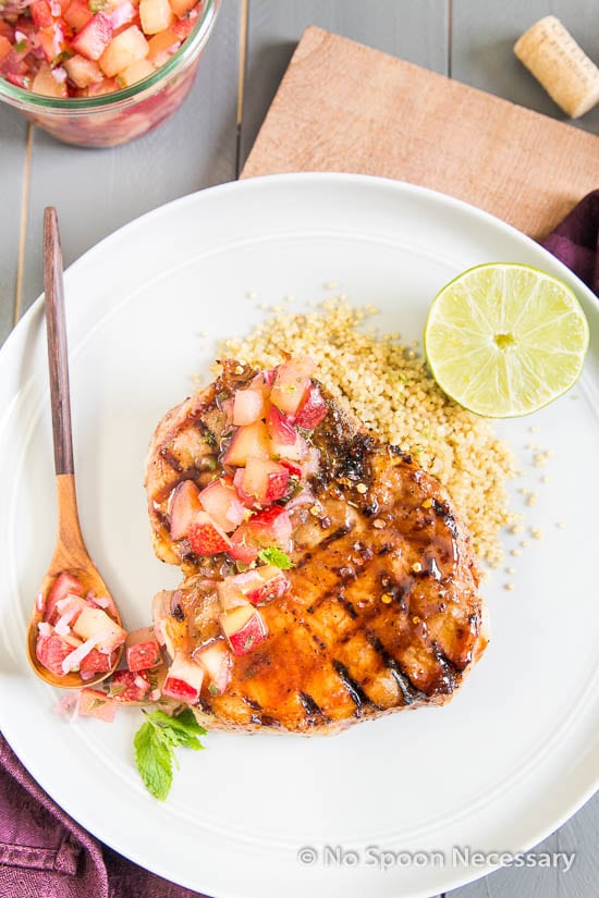 glazed pork chop over quinoa with a spoonful of plum salsa
