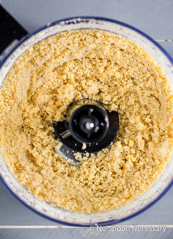 Overhead shot of a food processor bowl filled with processed chickpeas - the first part of step 3 in the recipe for Lox & Everything Bagel Hummus. 