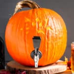 Straight on photo of a keg for beer made from a pumpkin.