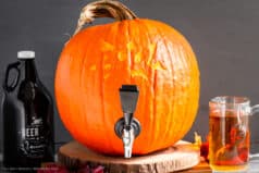 Straight on photo of a keg for beer made from a pumpkin.