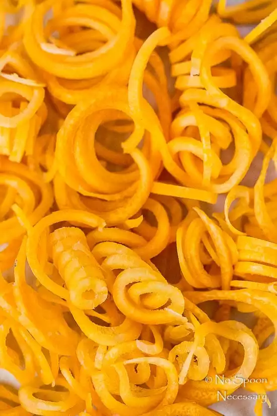 Overhead, up close shot of Carrot Noodle, one of the main ingredients in Honey Ginger Garlic Chicken Carrot Noodle Bowls.