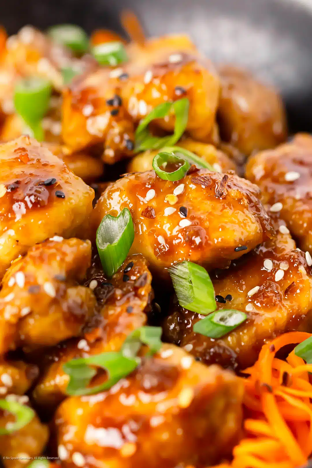 Angled, close-up photo illustrating the sticky sauce on honey garlic chicken noodles.
