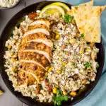 Overhead photo of Moroccan couscous recipe with sliced chicken breast in a serving bowl.
