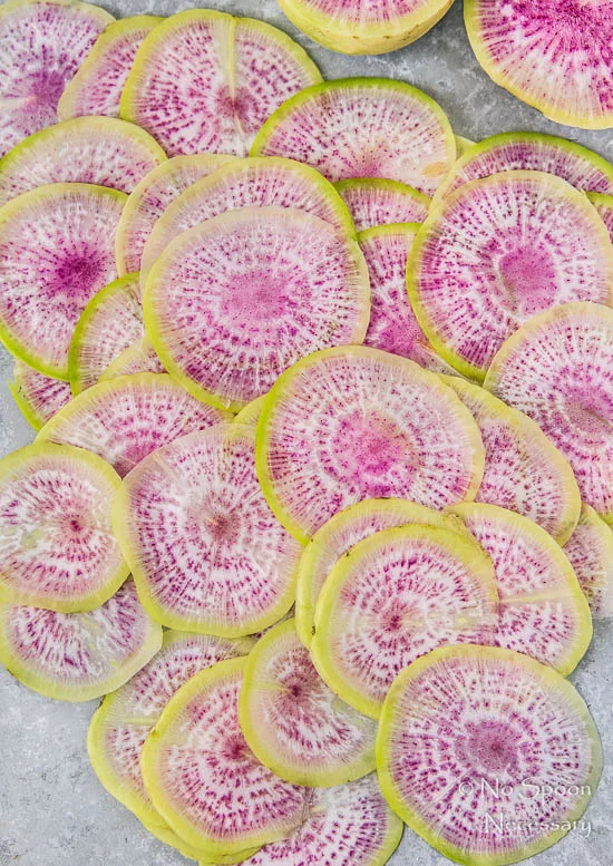 Overhead shot of thinly sliced watermelon radishes - one of the ingredients in a Ahi Tuna Spring Salad.