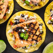Overhead photo of a salmon tostada with black beans and rice.