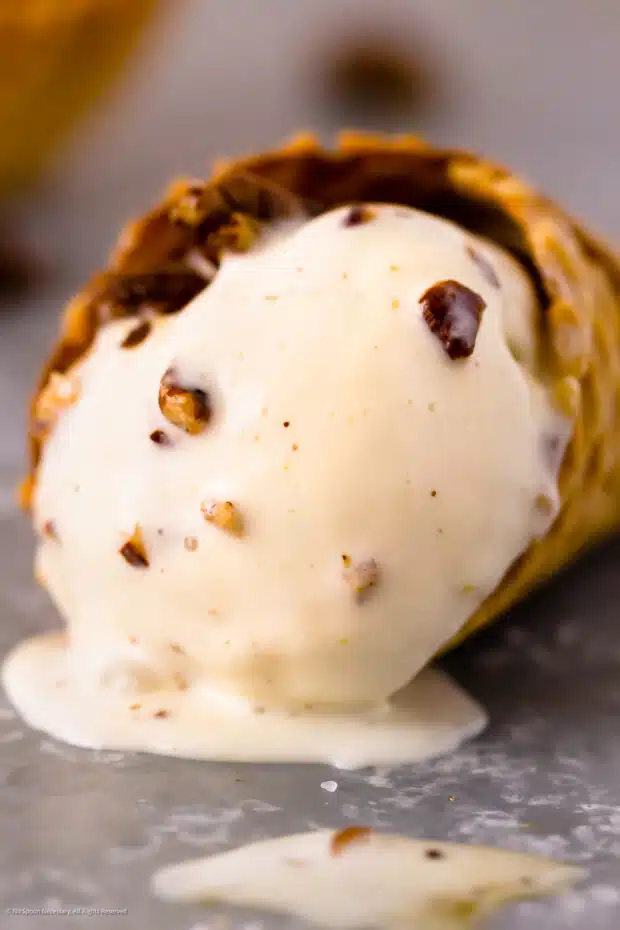 Photo of melting pecan ice cream in a waffle cone.