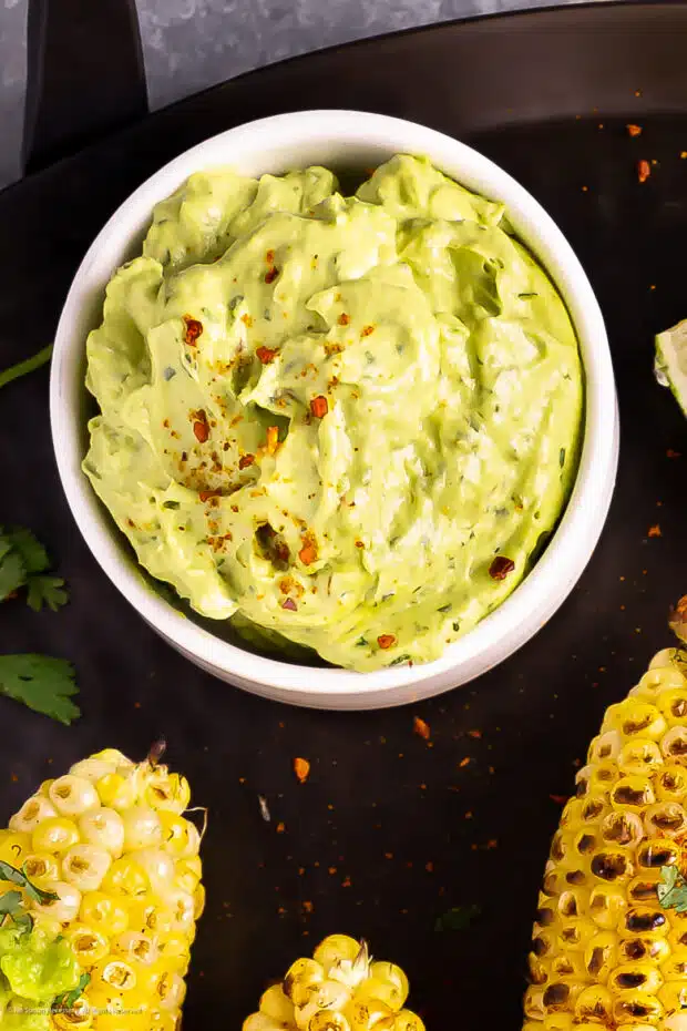 Overhead photo of avocado as butter spread in a white bowl.