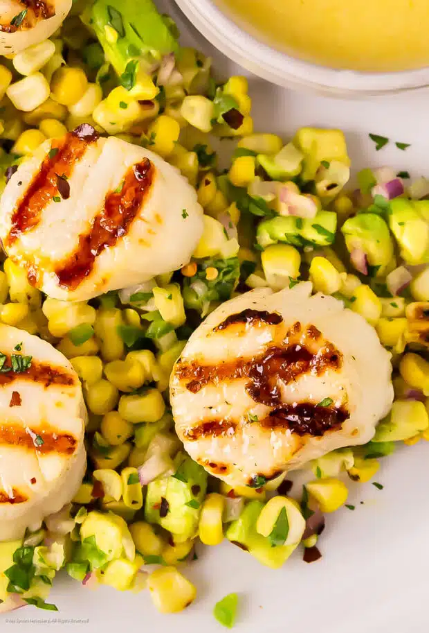 Close-up photo of a perfectly cooked scallop from this grill recipe.