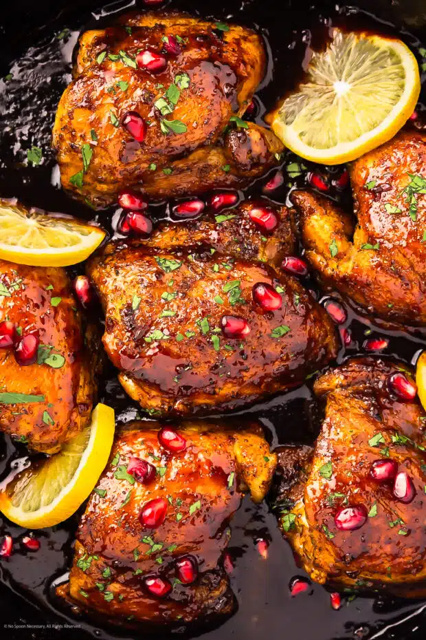 Close-up photo of chicken pomegranate things in a skillet.