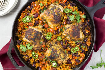 Overhead image of cajun chicken, red beans and rice in a large cast iron skillet.