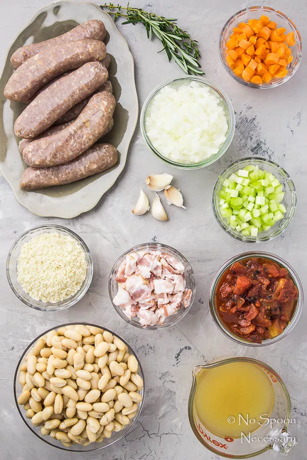 Overhead shot of the final ingredients wanted to tag Rooster Apple Sausage Hasty Cassoulet neatly organized in person bowls on a gray ground.  Easy and Hasty Cassoulet Quick Chicken Apple Sausage Cassoulet 10