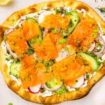 Overhead photo of smoked salmon pizza with cream cheese.