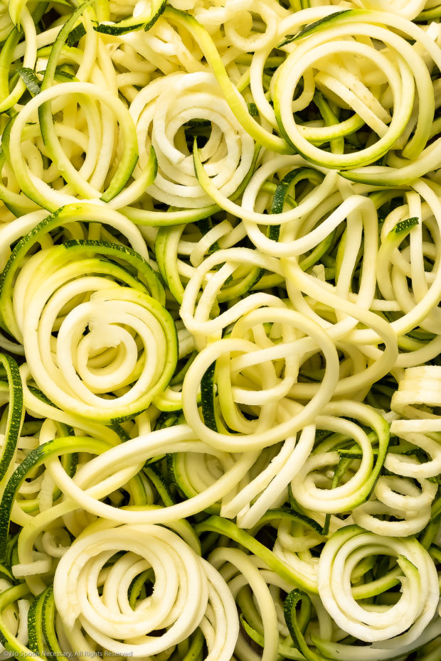 Overhead close-up photo of spiralized zucchini noodles - the main ingredient in salad recipe.