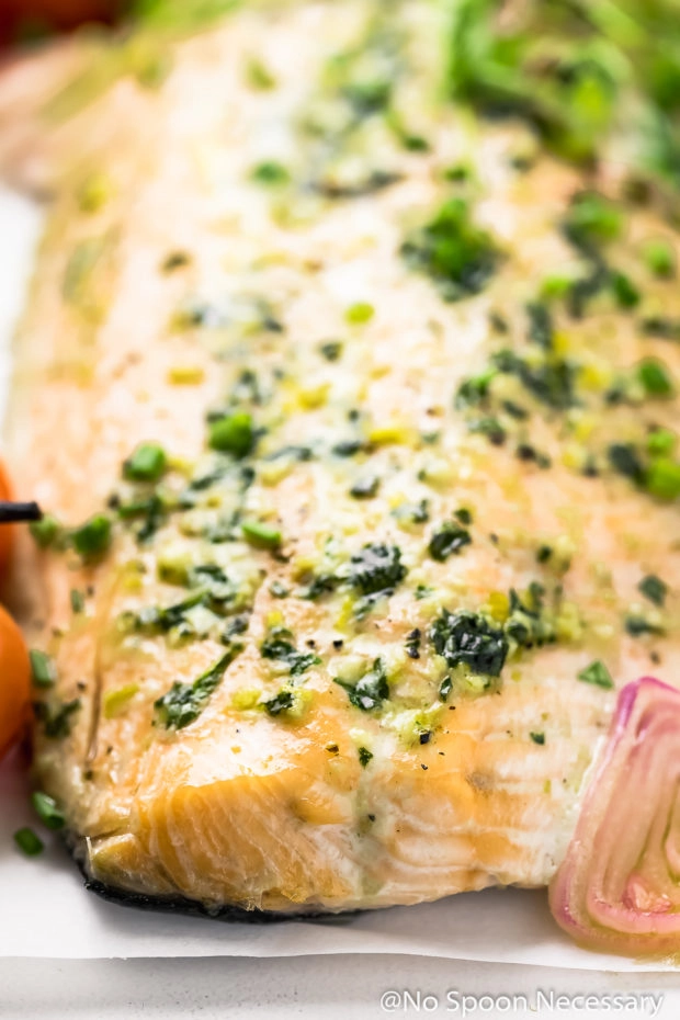 Angled, up close photo of Oven Baked Basil Butter Salmon.