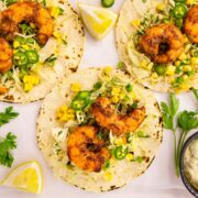 Overhead photo of three shrimp tacos with slaw.