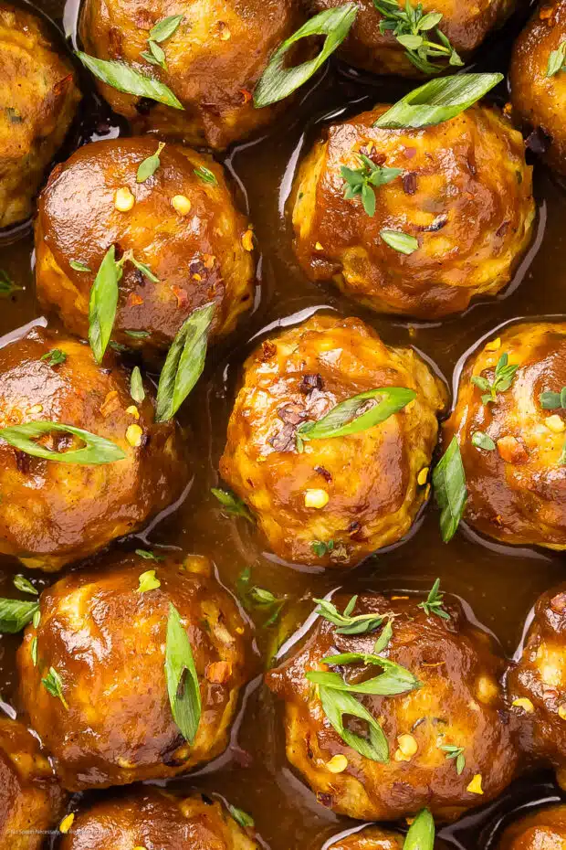 Close-up photo of meatballs with apple.