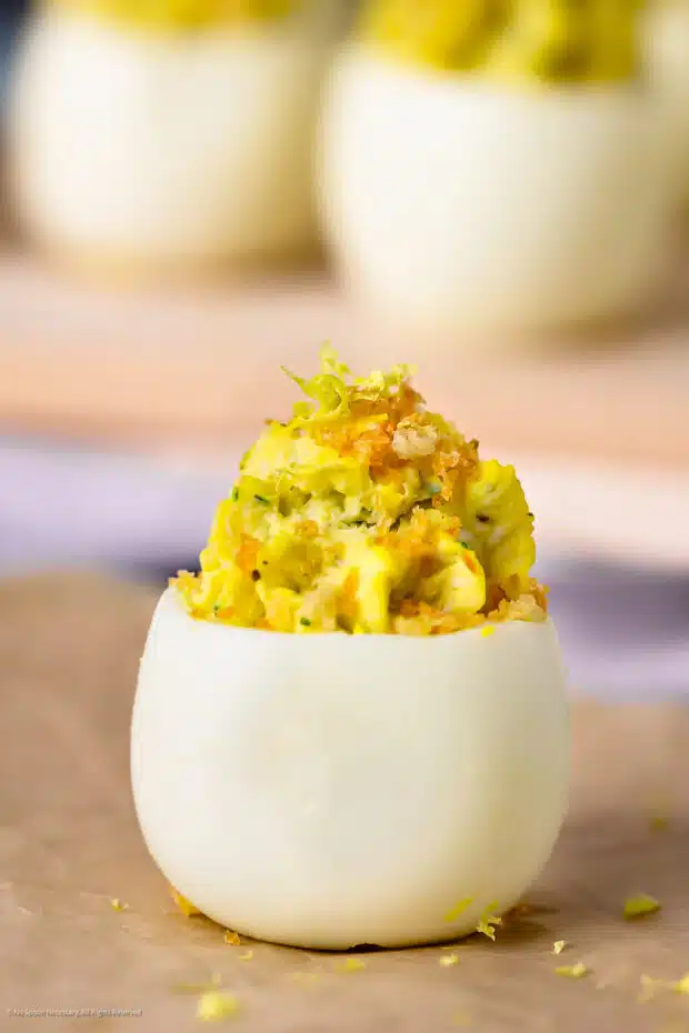 Straight on photo deviled crab eggs with chives.