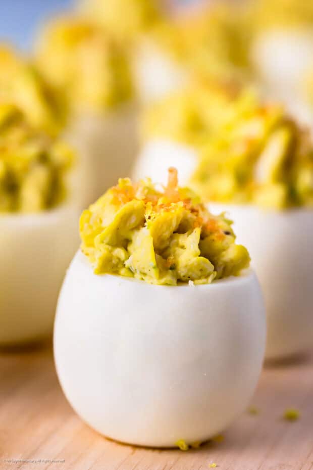 Straight on photo of a deviled egg with crab.
