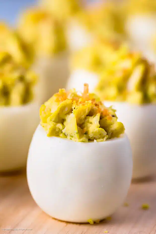 Straight on photo of a deviled egg with crab.