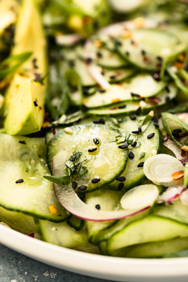 Angled, close-up photo of Sesame Cucumber Salad tossed with an Asian vinaigrette.