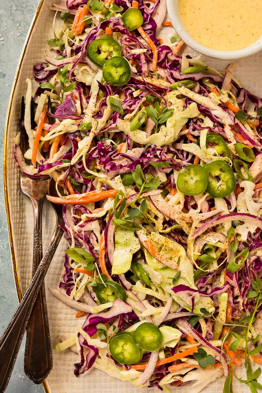 Overhead photo of jalapeno cilantro slaw with red cabbage, green cabbage, carrots, and cilantro.