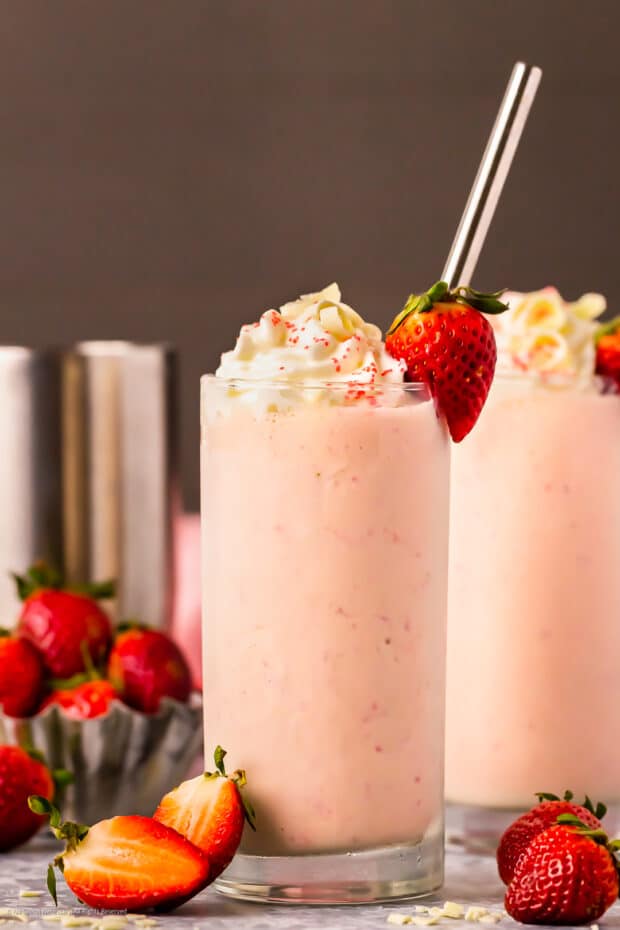 Straight on photo of a strawberry alcoholic milkshake with vodka.