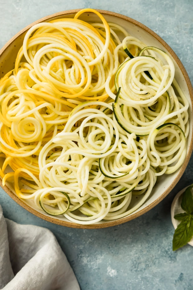 Overhead photo of a bowl containing prepared squash and zucchini noodles. (Prep photo of the pasta for the recipe.)