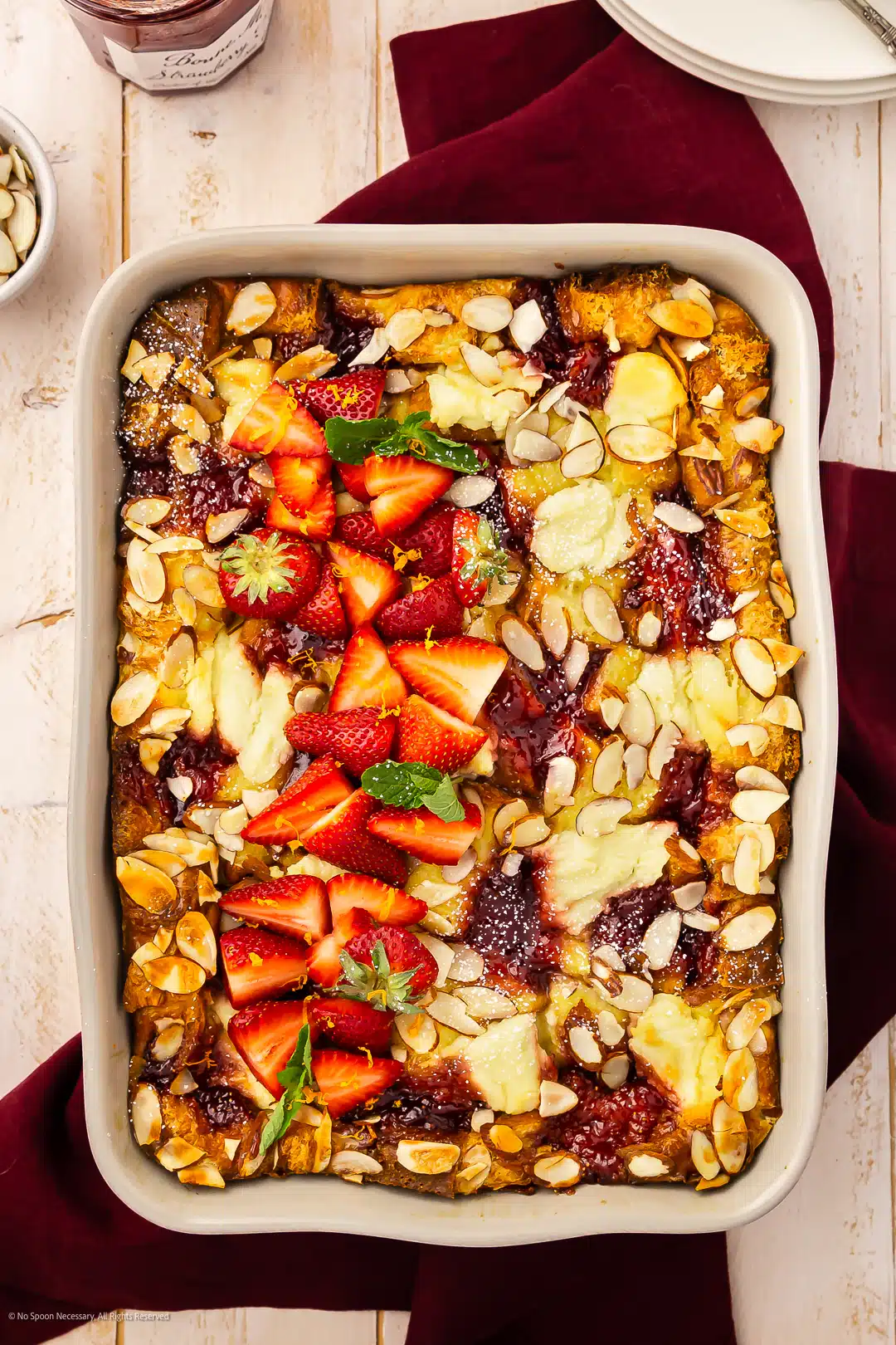 Overhead photo of a breakfast casserole with sweet strawberries and ricotta cheese.