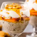 Straight on photo of a peaches pudding in a serving glass.