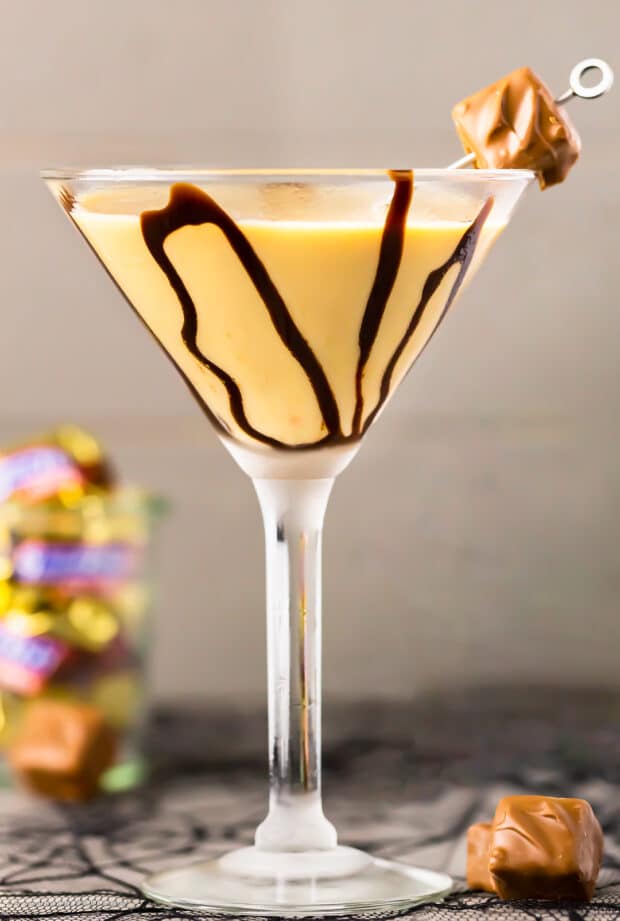 Straight on photo of a chocolate bar martini garnished with a candy bar in a martini glass.
