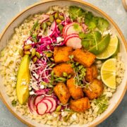 Overhead photo of a fish taco bowl with crispy white fish, slaw, and cauliflower rice.