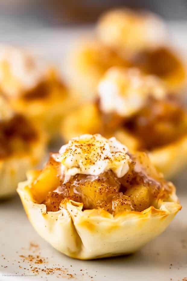 Straight on photo of a apple caramel bite made with puff pastry and apple pie filling.