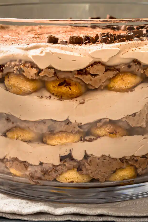 Close-up photo showing the three different layers in tiramisu with chocolate.