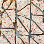 Overhead photo of Peppermint Bark cut into pieces on a piece of parchment paper.