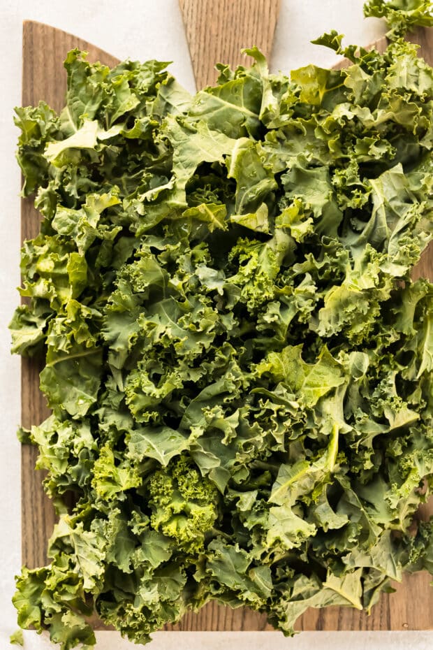 Overhead photo of fresh, raw kale for cooking and using in a salad.