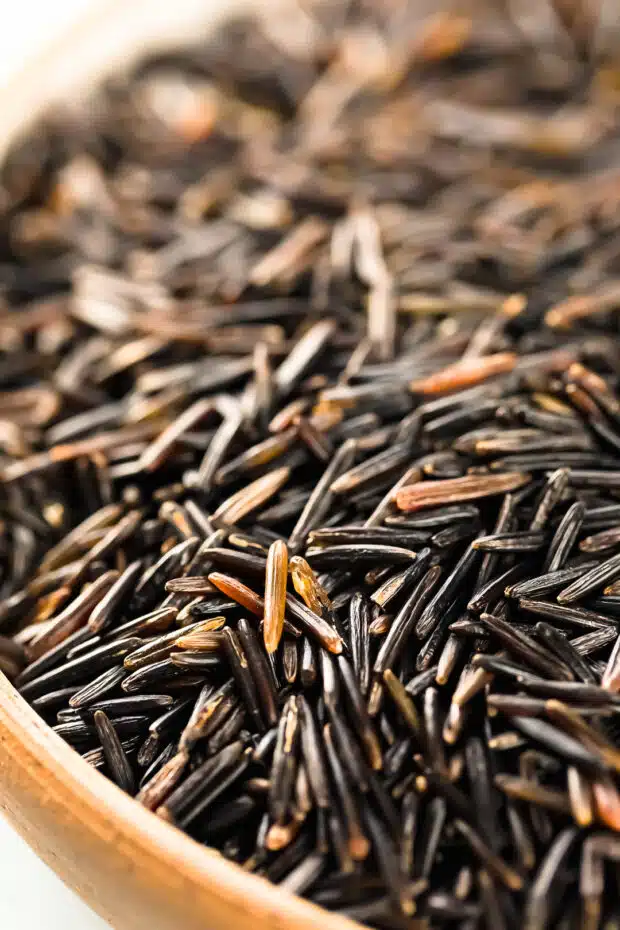 Close-up photo of uncooked wild rice grains.