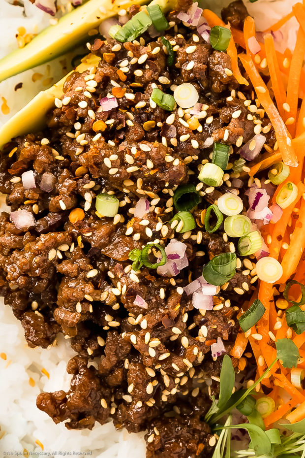 Overhead, close-up photo of ground beef stir-fried with a sweet and savory brown sauce. 