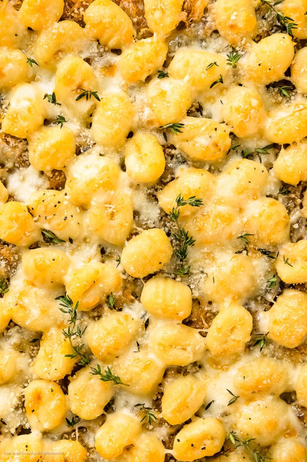Close-up photo of oven baked gnocchi with cheese.