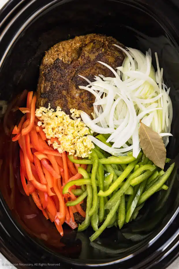 Overhead photo of the ingredients for ropa vieja in crock pot.