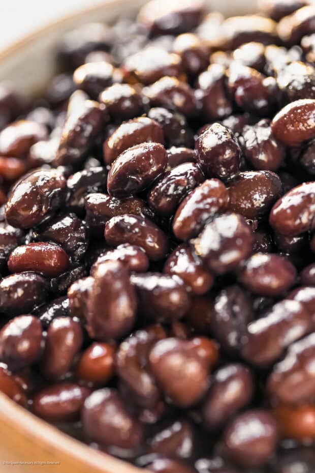 Close-up photo of black beans from a can.