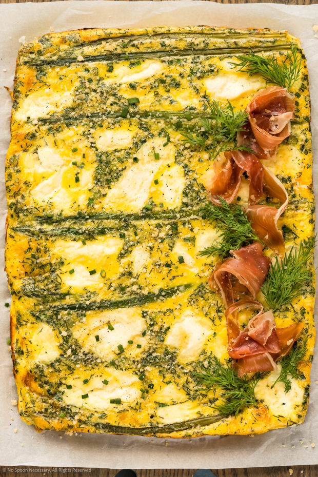Overhead photo of Asparagus Frittata baked and topped with dill and parmesan.